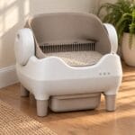 cleannest-open-top-self-cleaning-litter-box CleanNest open-top self-cleaning litter box in warm white and taupe on an oak floor in a sunlit room