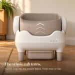 cleannest-open-top-self-cleaning-litter-box-how-it-cleans CleanNest litter box mid-clean, tub turned up. Text: The whole tub turns. Clumps drop into the drawer below.